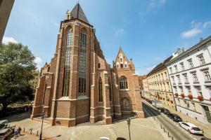 a large brick church with a tower on a street at 2/3 APARTMENTS Old Town in Wrocław