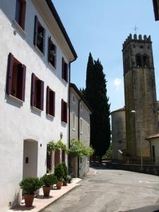 コネリアーノにあるCasa delle Bruscoleの時計塔と通り付きの白い建物