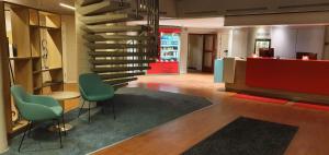 a lobby with a spiral staircase in a building at Good Morning Arlanda in Arlanda