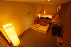 a small room with a bed and a table and a lamp at Kinnotake Tonosawa (Adult Only) in Hakone