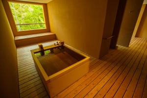 a room with a bench in front of a window at Kinnotake Tonosawa (Adult Only) in Hakone