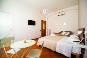 a bedroom with a bed and a table and a table at B&B il Faro in Salerno