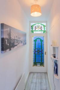a hallway with a door with stained glass at Windsor House in Derry Londonderry