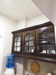Bourbon St Apts Condo 30C في انجلس: خزانة خشبية مع أبواب زجاجية في المطبخ