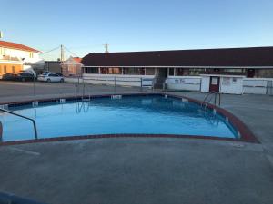 a large swimming pool in the middle of a parking lot at Royal Inn in Port Lavaca