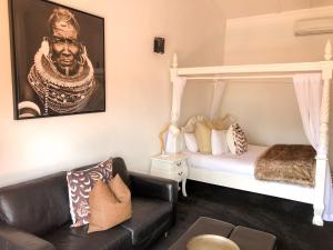 a living room with a bed and a couch at Orewa Beachcomber in Orewa