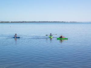 
two people in a canoe in the water at Twin Waters Caravan Park in Dawesville
