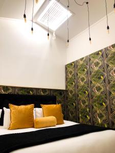 a bedroom with a bed with yellow pillows at Orewa Beachcomber in Orewa