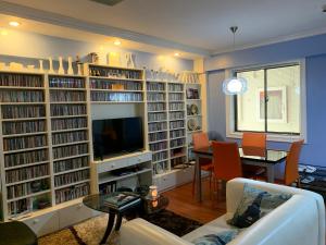 a living room filled with book shelves filled with books at Northpoint Camella Condo Suites in Davao City