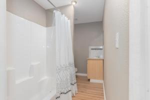 a bathroom with a shower curtain in a room at Sleepover Historic Downtown Springfield Apartments in Springfield