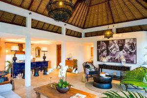 a living room with a couch and a table at Calma Ubud Suite & Villas in Ubud