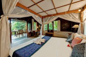 Postel nebo postele na pokoji v ubytování Kebun Indah Ubud