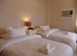 Ένα ή περισσότερα κρεβάτια σε δωμάτιο στο Citi Garden Suites