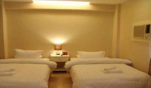 Ένα ή περισσότερα κρεβάτια σε δωμάτιο στο Citi Garden Suites