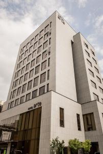 a large white building with a sign on it at Hotel Arte in Suwon