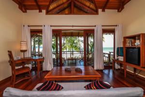 a living room with a couch and a table at Art of Sand Resort in Ngapali