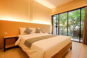 Säng eller sängar i ett rum på The Kubu Hotel