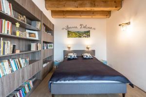 a bedroom with a bed in a room with bookshelves at APARTMANY L&O - Laura in Zvolenské Nemce