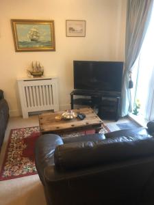 a living room with a couch and a coffee table at Tides Reach in Shanklin