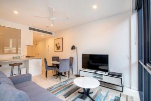 a living room with a couch and a table at Hope Street Apartments by CLLIX in Brisbane