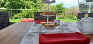a table with a cake and cups on top of it at Sunset Villa in Jimbaran
