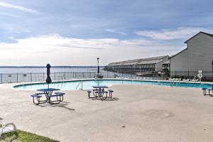 a pool with tables and chairs next to the water at Resort-Style Lake Conroe Retreat with Balcony and View in Willis