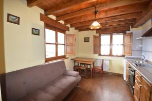 a living room with a couch and a table at Apartamentos La Huertina in Canales