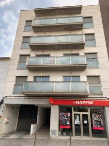 a large building with a store in front of it at Samsara Beach in Port d'Alcudia