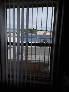 a view through a barred window of a airport at Pads on Pasadena Ave in Los Angeles