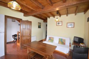 a bedroom with a bed and a wooden table at Apartamentos La Huertina in Canales