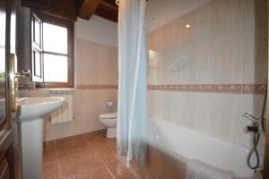 a bathroom with a toilet and a tub and a sink at Apartamentos La Huertina in Canales +41 photos