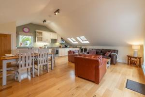 a living room with a couch and a table at 7 Sandy Lane in Carbis Bay