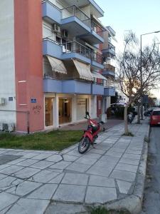 skuter zaparkowany na chodniku przed budynkiem w obiekcie Maria’s house w Salonikach