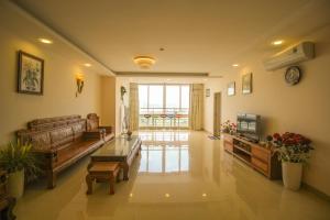 a living room with a couch and a table at The Grand Condotel in Vung Tau