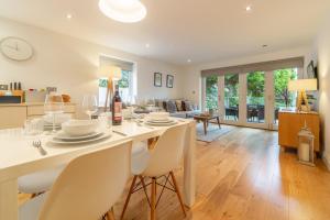 a dining room and living room with a table and chairs at 3 Sandy Lane in Carbis Bay