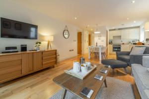 a living room with a couch and a table at 3 Sandy Lane in Carbis Bay