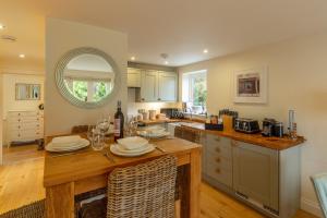 a kitchen with a table with plates on it at 6 Sandy Lane in Carbis Bay