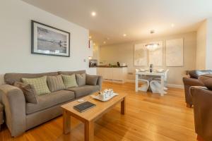 a living room with a couch and a table at 2 Four Seasons in Carbis Bay