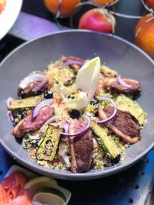 a plate of food with meat and vegetables on a table at Campanile Bayeux in Bayeux +51 photos