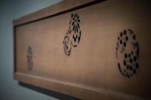a close up of a wooden wall withletters on it at Waqoo Shitaderamachi in Osaka