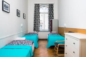 
a bed room with two beds and a desk at Hostel Diana Park in Helsinki
