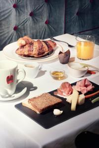a table with a plate of breakfast food on it at Speronari Suites in Milan