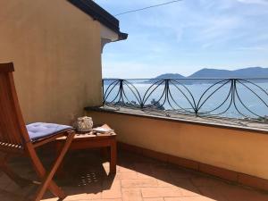 Una silla en un balcón con vista al mar. en La Gora, tra mare e sentieri, en Lerici