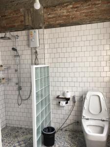 a white bathroom with a toilet and a shower at PX122 DBEST HOTEL in Nan