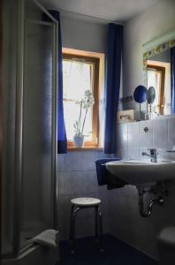 a bathroom with a sink and a shower at Pension Mühlbauer in Bayrischzell