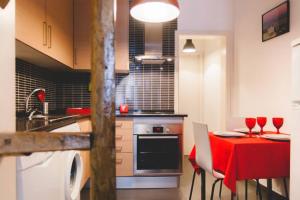 a kitchen with a table with wine glasses on it at Welcome to Alcântara Apartment in Lisbon