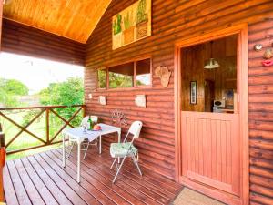 a wooden cabin with a table and chairs on a deck at Yorkdale Cabin in Sabie