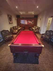 a pool table in a living room with couches at The Stafford in Blackpool
