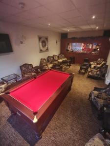 a living room with a pool table and chairs at The Stafford in Blackpool +24 photos