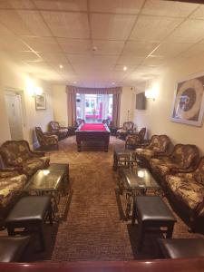 a waiting room with couches and a pool table at The Stafford in Blackpool